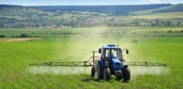tractor crop spray farm fields herbicides