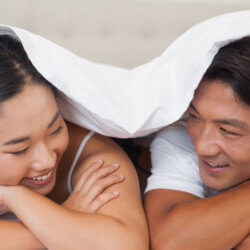 couple smiling in bed