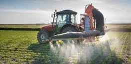 tractor spraying pesticides iowa
