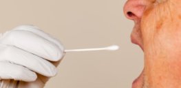 saliva swab being taken from man