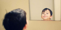 boy looking into mirror