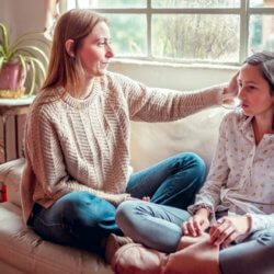 mother and daughter at home having a serious talk x header x