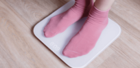 legs of a young woman measuring her weight on a pz sdwc x
