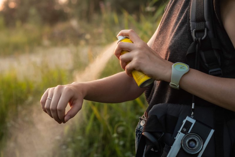 Woman,Using,Anti,Mosquito,Spray,Outdoors,At,Hiking,Trip.,Close-up