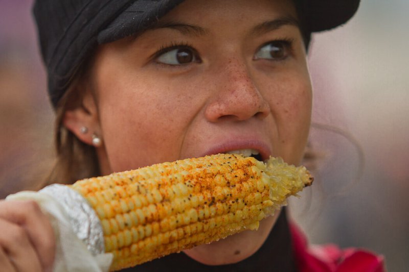 Woman eating Corn