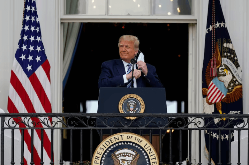 President Donald Trump removes his face mask to speak from the Blue Room Balcony of the White House to a crowd of supporters in Washington.

Credit: Alex Brandon/AP