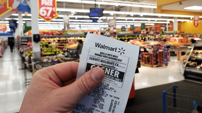 a-person-holding-up-a-receipt-from-a-walmart-superstore-in-montreal-quebec