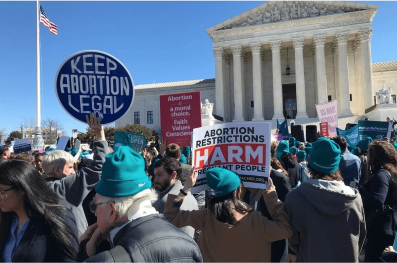 Demonstrators rally before the U.S. Supreme Court, which overturned Roe v. Wade, the landmark case that found Americans have the right to an abortion. Missouri doctors worry the state’s new abortion ban could put women with high-risk pregnancies in danger.              Credit: Robin Bravender/States Newsroom