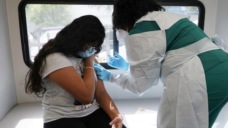 Jenna Ramkhelawan, 12, receives the first dose of the Pfizer Covid-19 vaccine. Credit: Marta Lavandier/AP