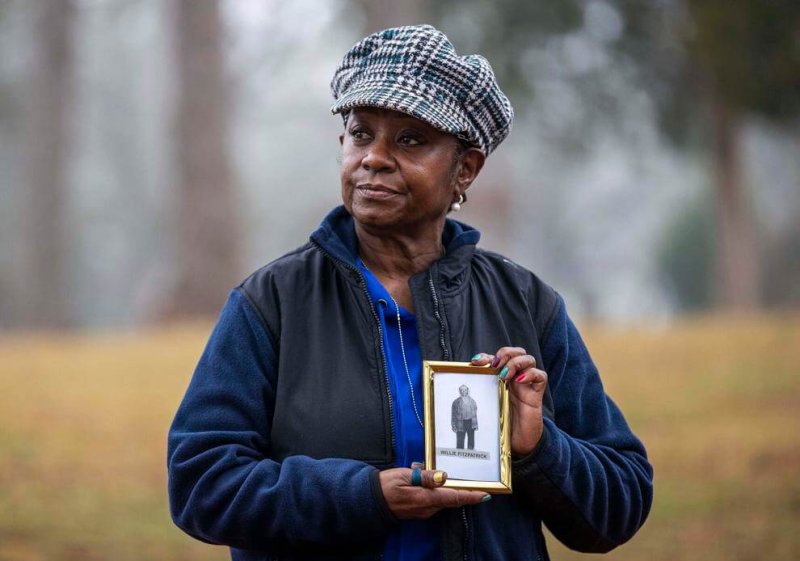 Peggy Fitzpatrick, 65, holds an image of her great grandfather Willie Fitzpatrick, a victim of the Tuskegee Experiments. Despite this, Peggy will still get the COVID vaccine. Credit: Alyssa Pointer