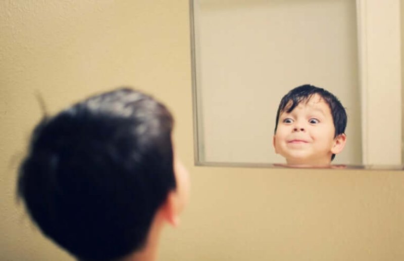 boy looking into mirror