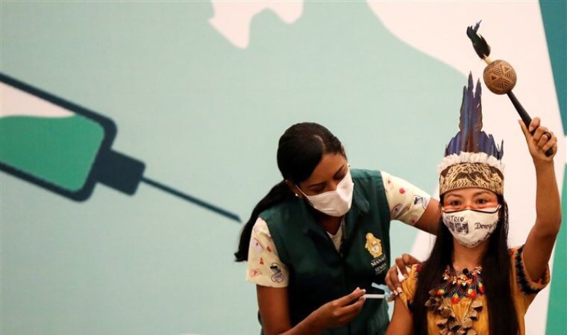 Vanderlecia Ortega dos Santos from the Witoto indigenous tribe, receives a COVID vaccine in Manaus. Credit: Bruno Kelly/Reuters