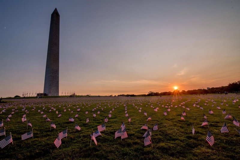 Flags surround the Washington Monument in a September memorial erected as the U.S. COVID-19 death toll passed 200,000. Credit: Angela N.