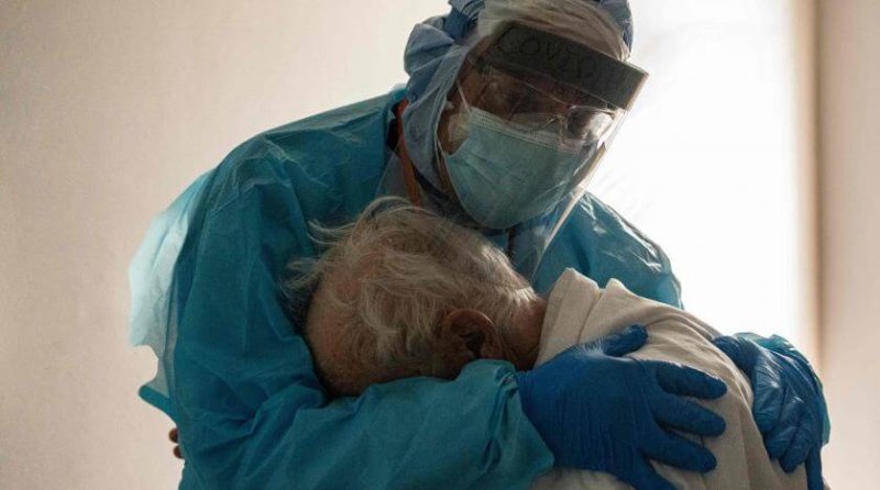 Dr. Joseph Varon comforts an elderly patient in the Covid-19 intensive care unit at the United Memorial Medical Centre in Houston, Texas. Credit: AFP