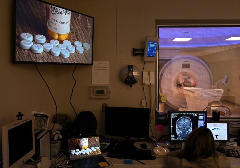 Gerod Buckhalter, in an MRI machine, is shown pictures of addiction triggers as researchers monitor his brain activity. Credit: Washington Post