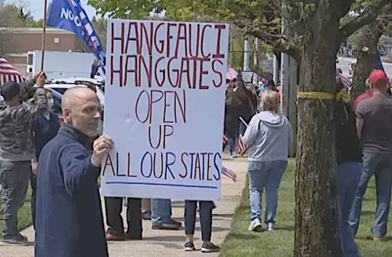 Protester holds disturbing sign at anti-lockdown rally. Credit: News 12 Long Island