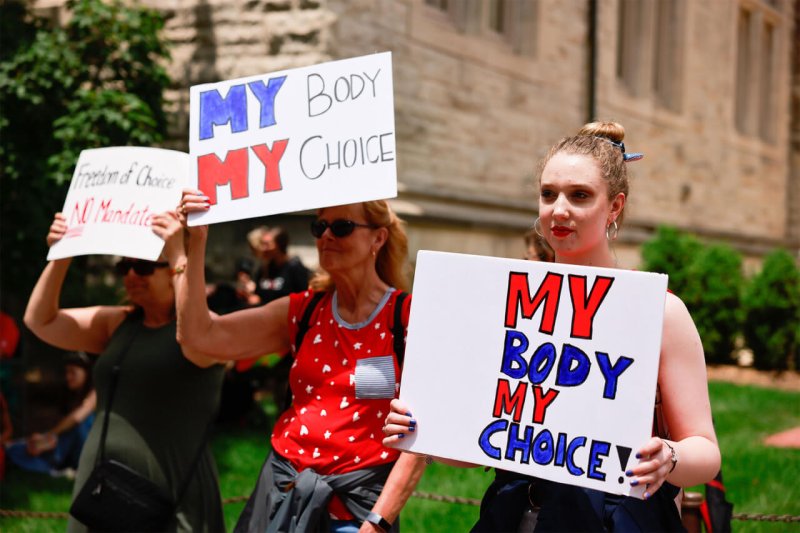 Group gathered at Indiana University’s Sample Gates to protest against mandatory Covid vaccinations. Credit: Jeremy Hogan/SOPA Images/Shutter