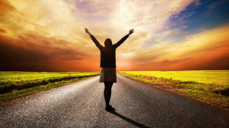 longevity happy woman standing hands on long road x