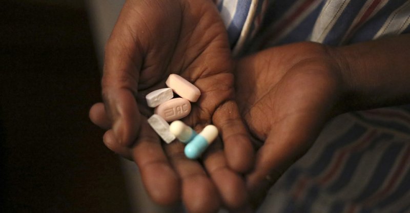 A child at Nkosi's Village, an NGO in South Africa, holds his antiretroviral pills. Credit: Siphiwe Sibeko/Reuters