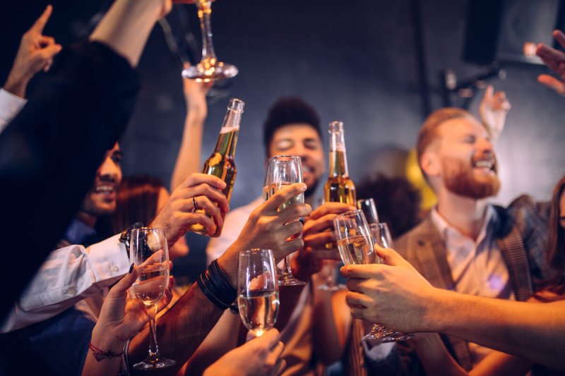 people are drinking alcohol at a party but it could lead to liver cancer