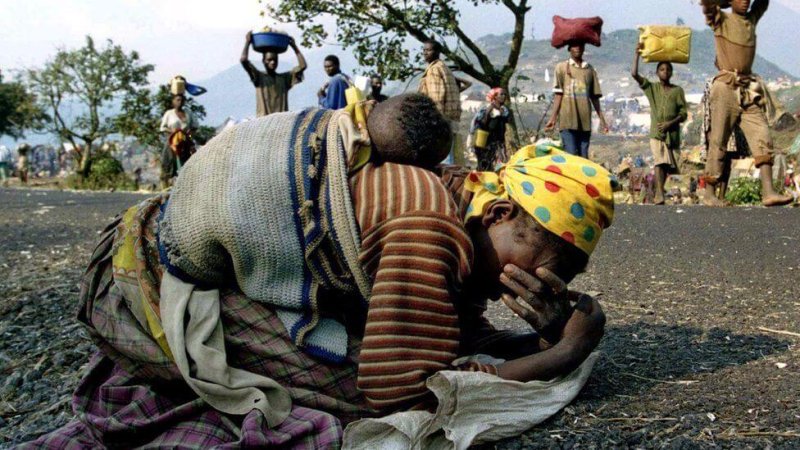 A woman collapses after fleeing Rwanda in 1994. Credit: Reuters