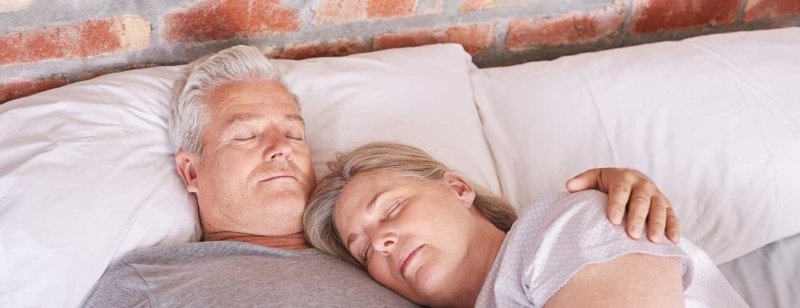 senior man sleeping with wife hero