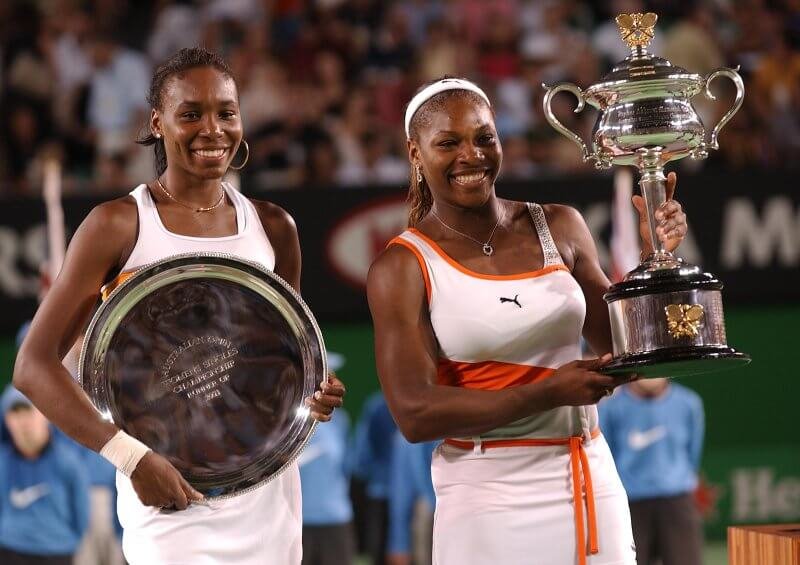 Serena and Venus Williams with their trophies after Serena beat her sister in the 2003 Women's Singles Final. Credit: Phil Walter/EMPICS