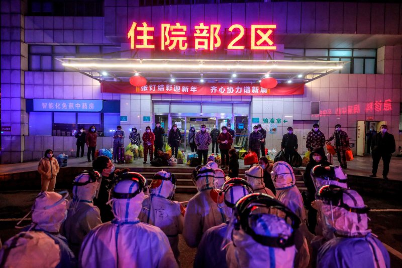 COVID patients infected wait to be transferred from Wuhan No.5 Hospital to Leishenshan Hospital, a newly-built hospital in Wuhan. Credit: STR/AFP