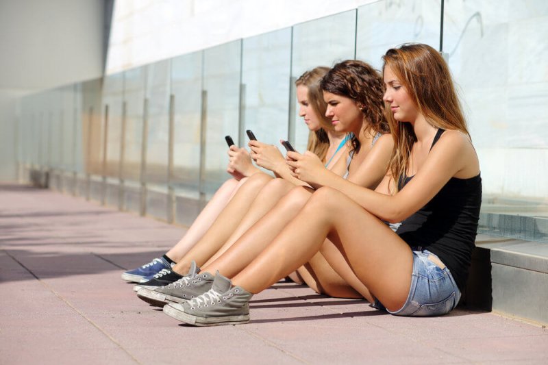 teenage girls with phones
