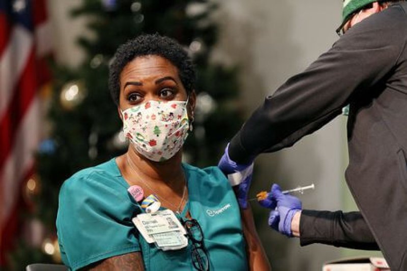 Demali Beard, a registered nurse, is given the COVID-19 vaccine. Credit: Mike Mulholland