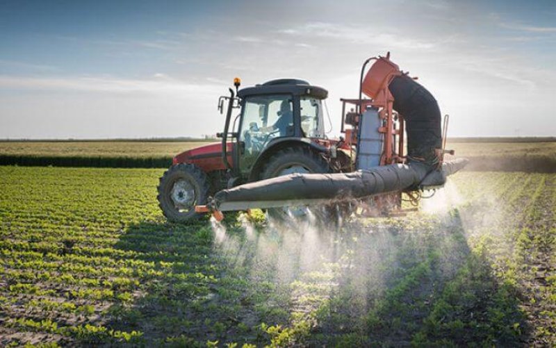 tractor spraying pesticides iowa