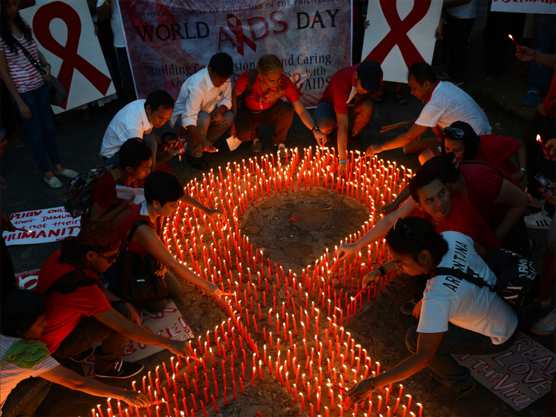 Activists light candles on World Aids Day in Manila. Credit: Getty Images