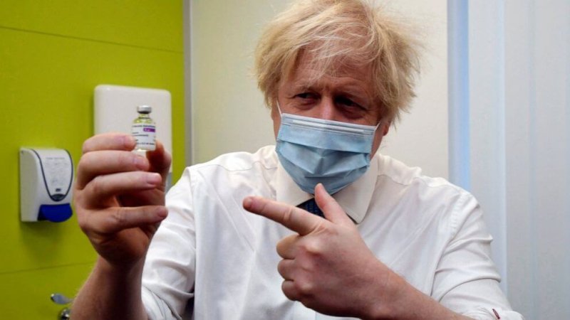 Britain's Prime Minister Boris Johnson holds a vial of the AstraZeneca vaccine. Credit: Jeremy Selwyn/AP