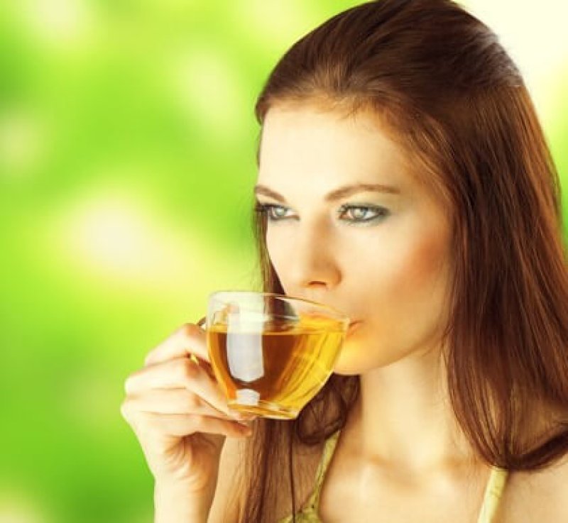 young female drinking green tea