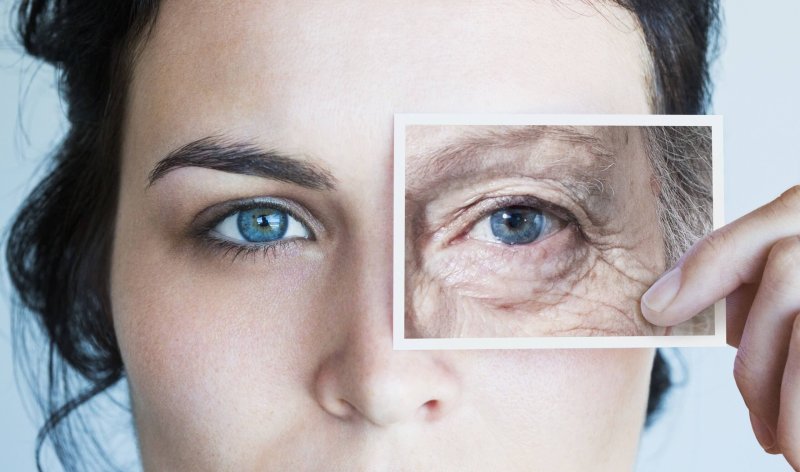 young woman with photo of aged eye over her high res stock photography